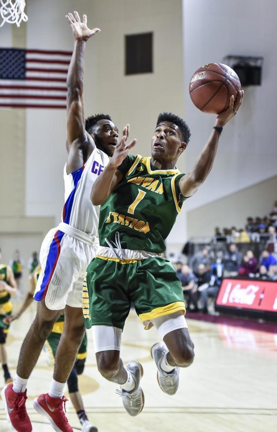 Bryan Station's Terrance Clayton-Murphy (1) shoots a lay up around Madison Central's Isaiah Minter (5), during the first round of the 11th Region tournament, Wednesday night, February 28, 2018, at EKU's McBrayer Arena in Richmond.