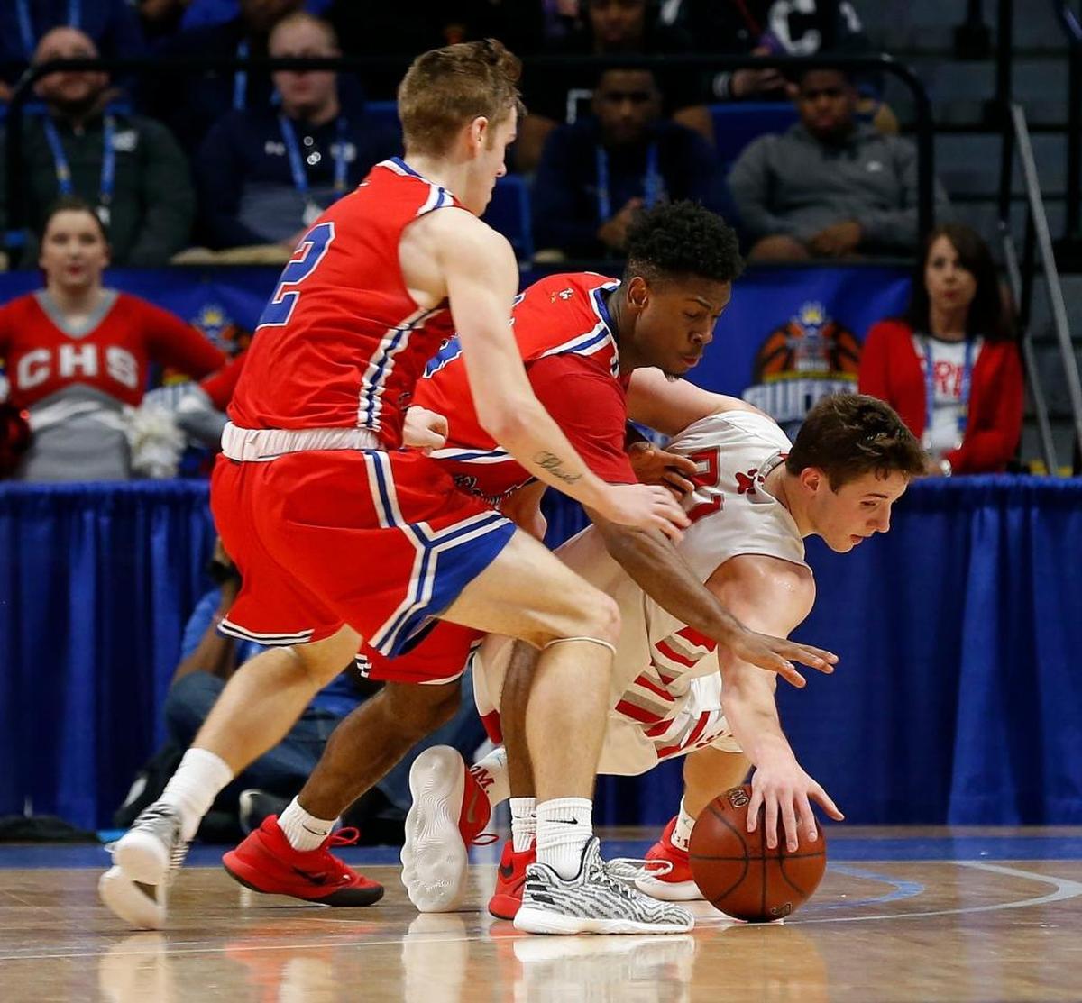 Scott County guard Bryce Long (2), Scott County guard Glenn Covington (14) and Corbin guard Andrew Taylor (21) went after a loose ball as Scott County played Corbin in the quarterfinal round of Whitaker Bank/KHSAA Boys' Sweet Sixteen in Rupp Arena. This is third quarter action. Scott County won 73-62.