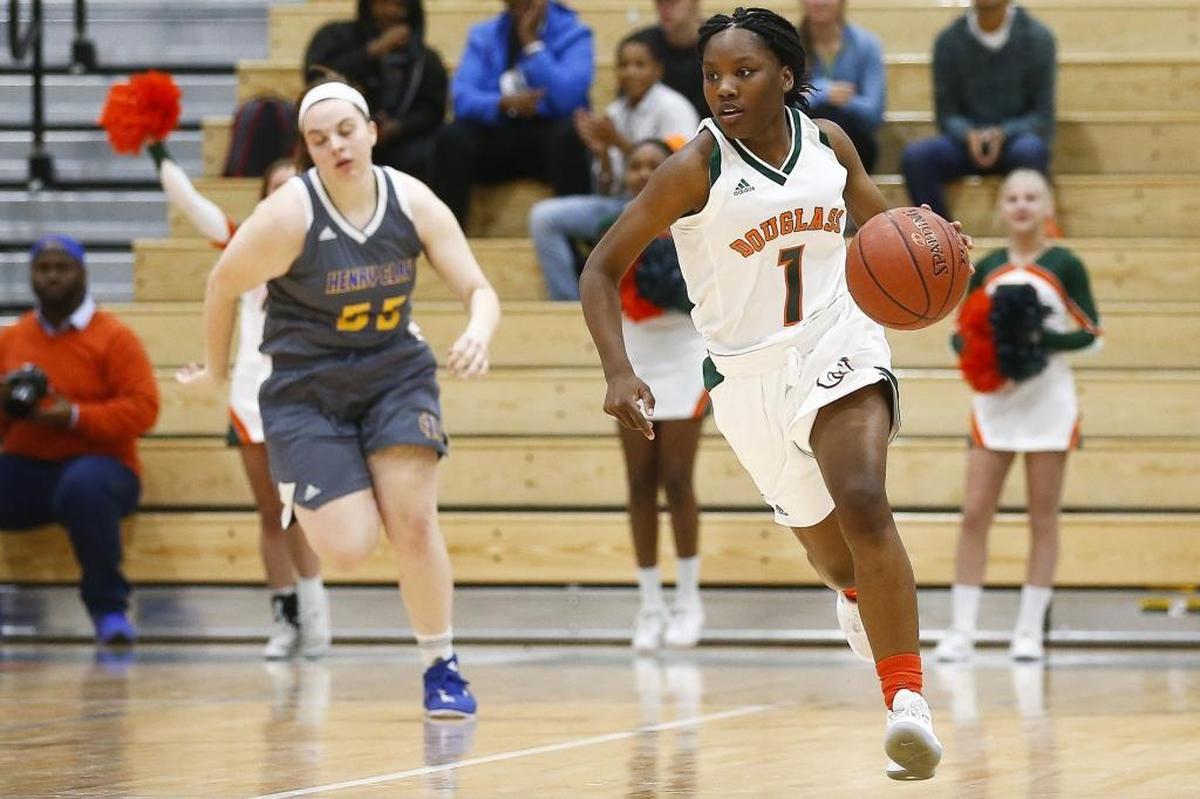Frederick Douglass' Destyne Jackson (1) drives down court past Henry Clay's Grace Branchini (55) during their game at Frederick Douglass High School in Lexington, Ky., Tuesday, Nov. 28, 2017.