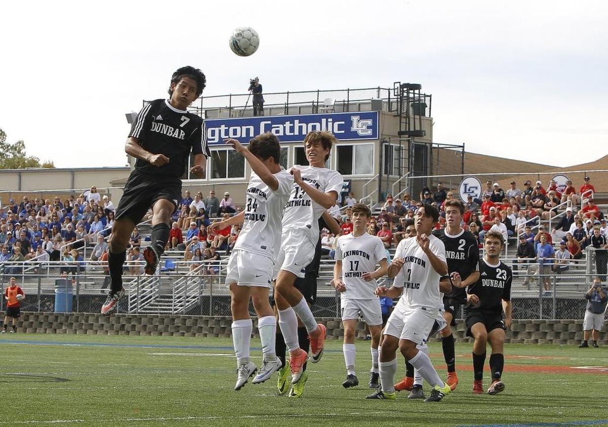 Paul Laurence Dunbar's Eddy Andrade heads on goal off the corner kick against Lexington Catholic in the 11th region boys soccer final at Joseph Ford Stadium in Lexington, Ky., Saturday, October 21, 2017.