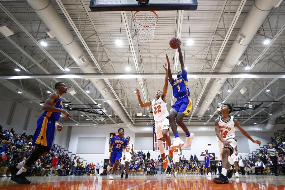 Henry Clay's Marques Warrick (3) shoots past Frederick Douglass' Jayden Brown (22) during their game at Frederick Douglass High School in Lexington, Ky., Tuesday, Nov. 28, 2017.