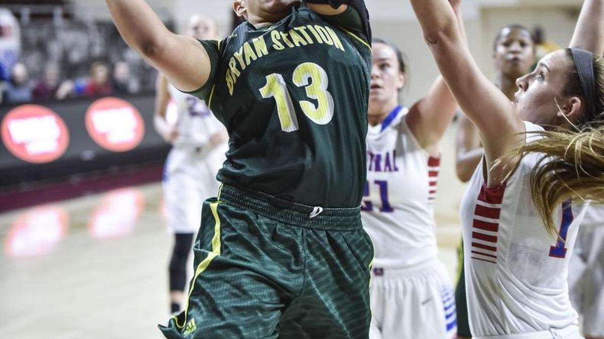 Bryan Station's Carah Burdette (13) shoots over Madison Central's Bailee Vanover (1), during the quarterfinal round of the girls 11th Region tournament, Tuesday, March 1, 2016, at EKU's McBrayer Arena in Richmond.