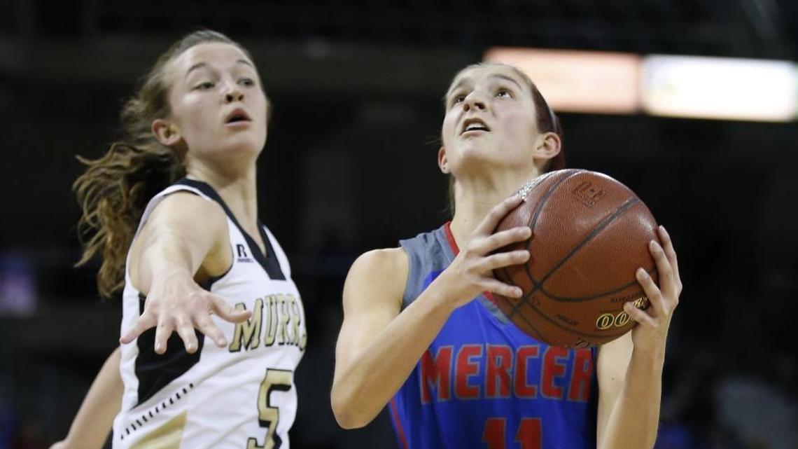 Mercer County's Faith Lake, 11, drives to the basket in front of Murray's Macey Turley, 5, during a first round game of the St. Elizabeth Healthcare/KHSAA Girls' Sweet 16 basketball tournament played at BB&T Arena in Highland Height, Ky. Wednesday March 7, 2018.