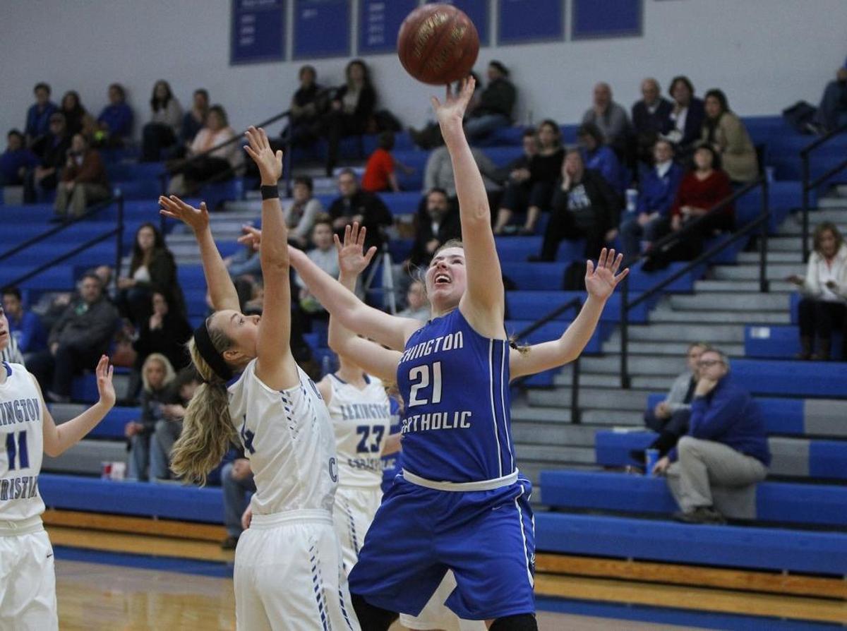 Lexington Catholic's Jay Ballard shoots against Lexington Christian Academy's Payton Rogers, left, at LCA gymnasium in Lexington, Ky., Friday, February 3, 2017.