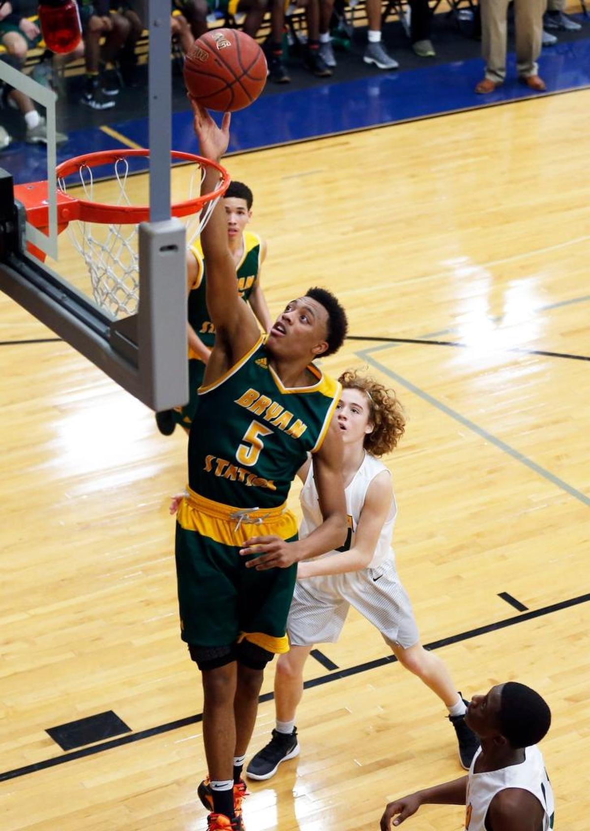 Bryan Station's Eric Boone scored on a drive past University Heights’ William Bryan as Bryan Station High School played University University Heights in theTraditional Bank Holiday Classic played at Lexington Catholic High School in Lexington Ky., Wednesday, December 27, 2017. Bryan Station won 82-69.