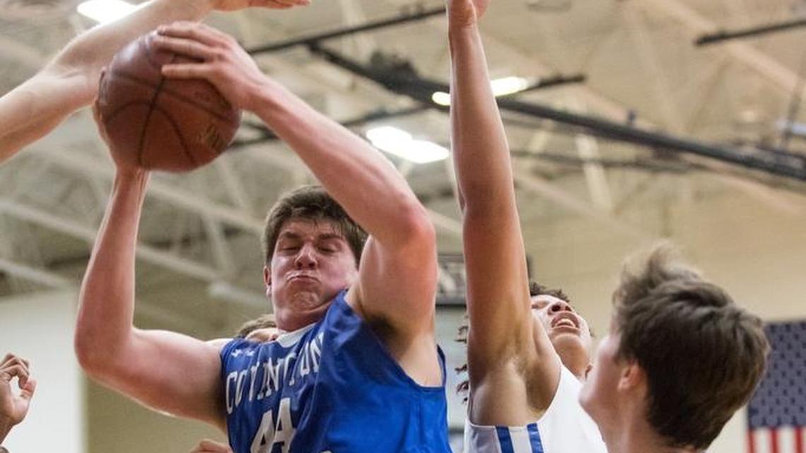 Covington Catholic's Jake Walter (44) with the rebound as host Lexington Catholic came up short 54-53 against Covington Catholic on Wednesday Nov. 29, 2017 in Lexington, Ky.