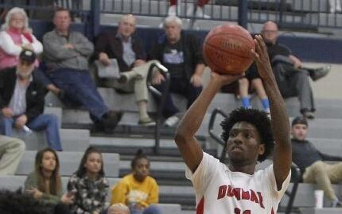 Paul Laurence Dunbar's Taveion Hollingsworth shoots against Russellville during the boys' Traditional Bank Holiday Classic in the Beuter Gymnasium at Lexington Catholic in Lexington, Ky., Tuesday, December 27, 2016.