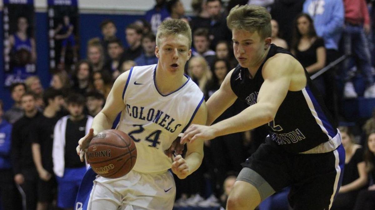 Oldham County senior Branden Dewitt, left, brought the ball up the floor during a game against Simon Kenton in February.