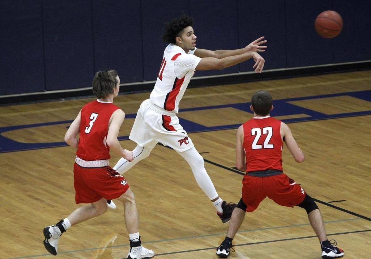 Pendleton County’s Dontaie Allen, passing, enters his senior season having scored 20 points or more in 80 of the 105 high school basketball games in which he has played. Allen committed to the University of Kentucky on Thursday.