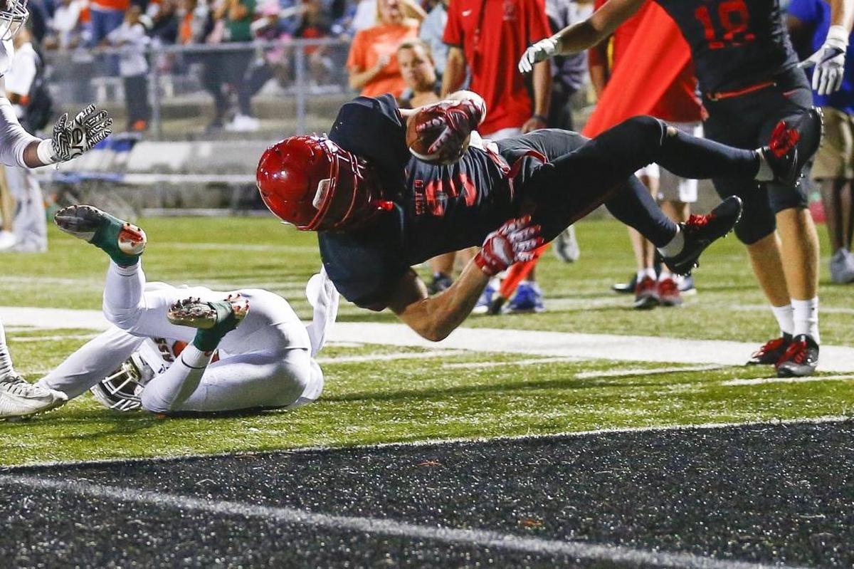 Scott County's Brice Fryman (3) scores a touchdown past Frederick Douglass' Daiyaan Perkins (19) during their game at Toyota Stadium in Georgetown, Ky., Friday, Oct. 6, 2017.