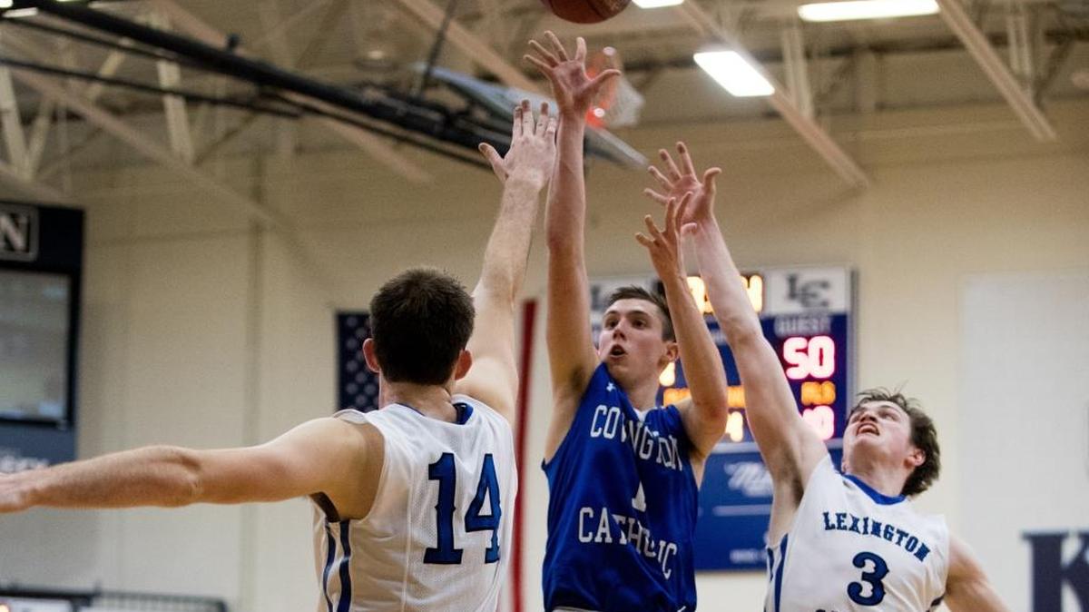 Covington Catholic's CJ Fredrick (1) shot over Lexington Catholic's Max Sparkman (14) and TC Price (3) as host Lexington Catholic came up short 54-53 against Covington Catholic on Wednesday Nov. 29, 2017 in Lexington, Ky.