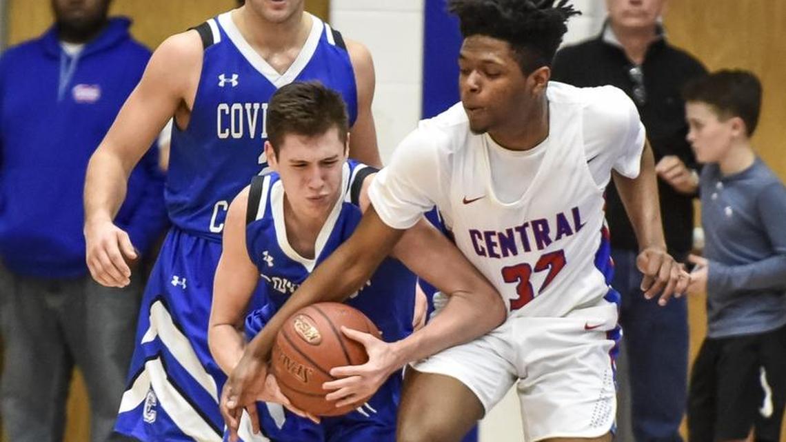 Covington Catholic’s CJ Frederick, left, tried to dribble past Madison Central’s Kenyon McKee on Feb. 16 in Richmond.