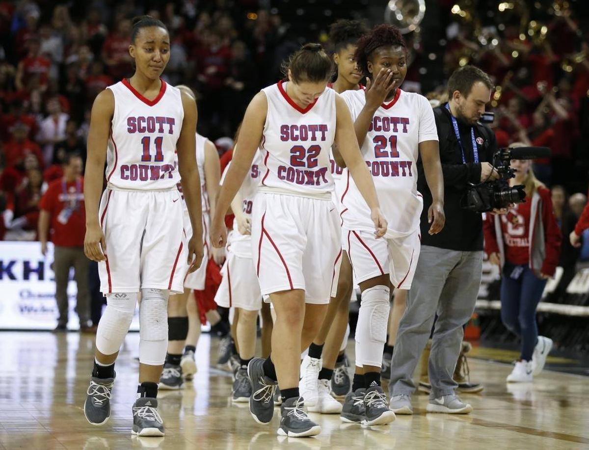 Scott County players Maaliya Owens (11), Peyton Riddle (22) and Zakiyia Holt (21) left the court after their loss to Manual at Highland Heights on Thursday.