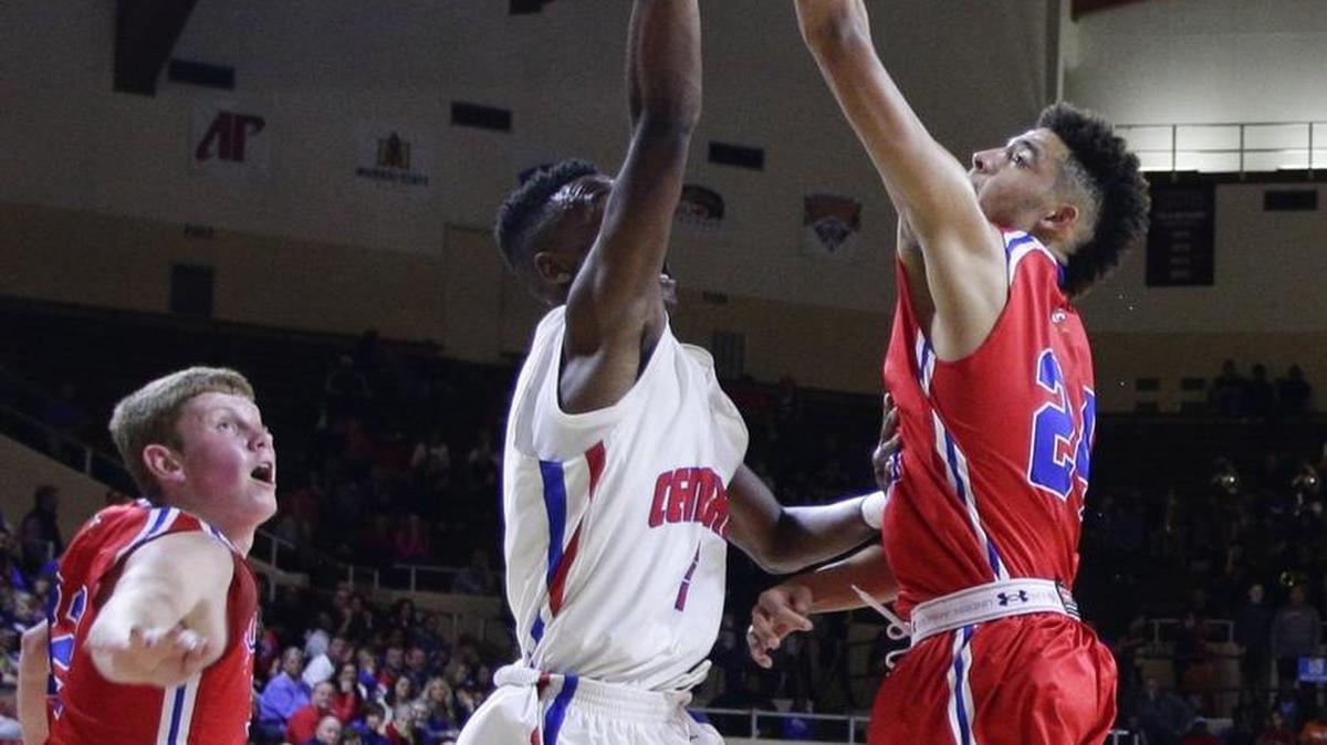 Madison Central's John Williams had his shot blocked by Scott County’s Michael Moreno during last season’s 11th Region Tournament.