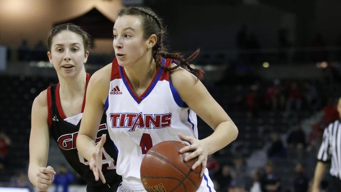 Mercer County's Seygan Robins, 4, drives to the basket in front of George Rogers Clark's Hayley Harrison, rear, during a semi final game in the St. Elizabeth Healthcare/KHSAA Girls' Sweet 16 basketball tournament played at BB&T Arena in Highland Height, Ky. Saturday March 10, 2018.