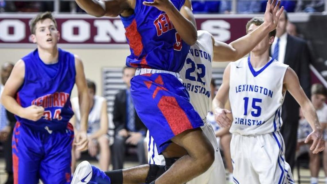 Madison Central's Isaiah Minter (5) scores in the lane against LCA's Kyle Rode (22), during the boys 11th Region Tournament, Thursday night, March 2, 2017, at EKU's McBrayer Arena in Richmond.