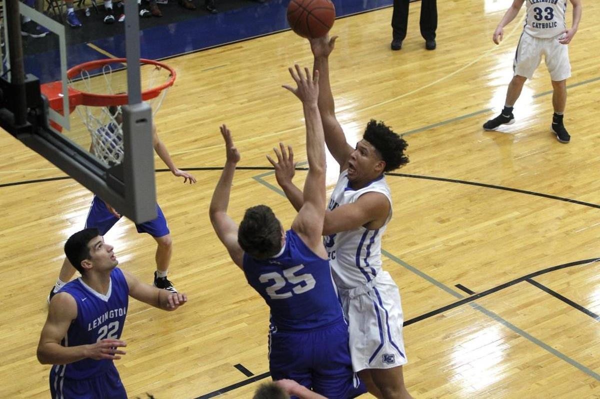 Lexington Catholic's Zan Payne shoots against Lexington Christian's Austin Hall in the Bueter Gymnasium at Lexington Catholic in Lexington, Ky., Tuesday, January 2, 2018.