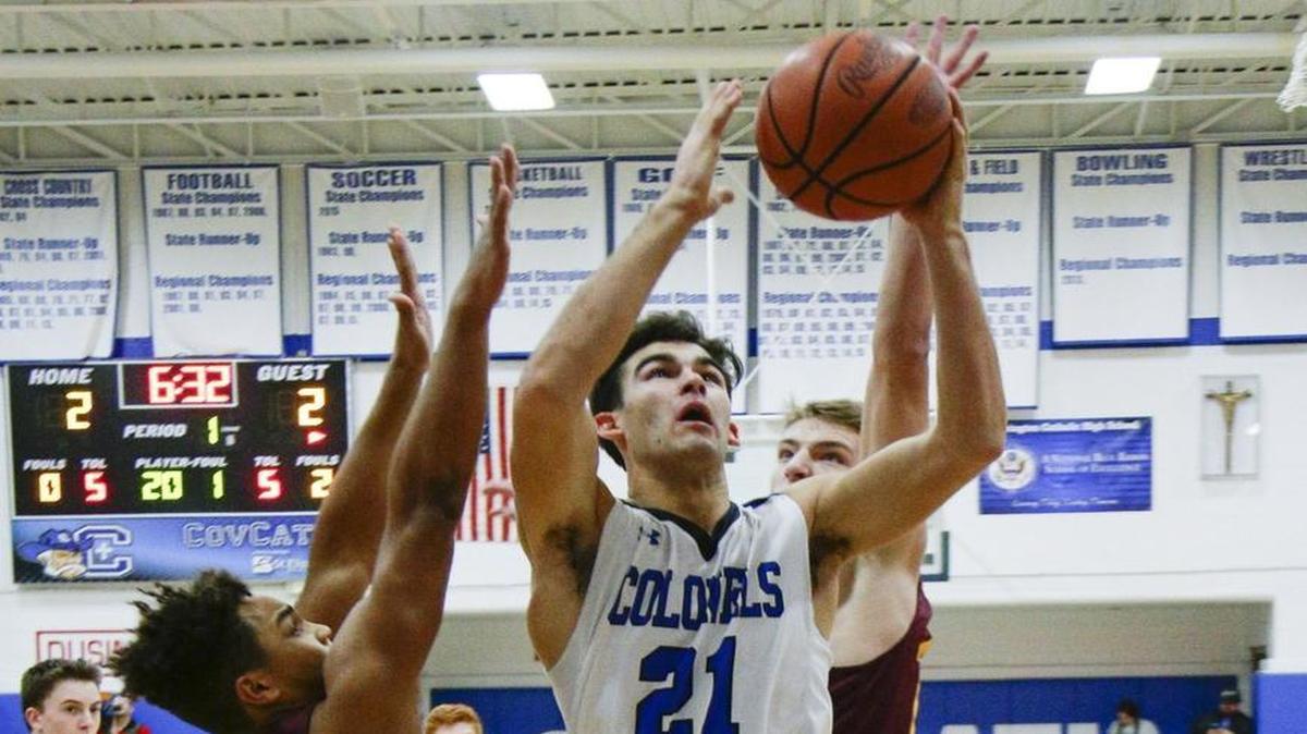 Covington Catholic’s A.J. Mayer scored in traffic against Cooper on Jan. 18 in Park Hills.