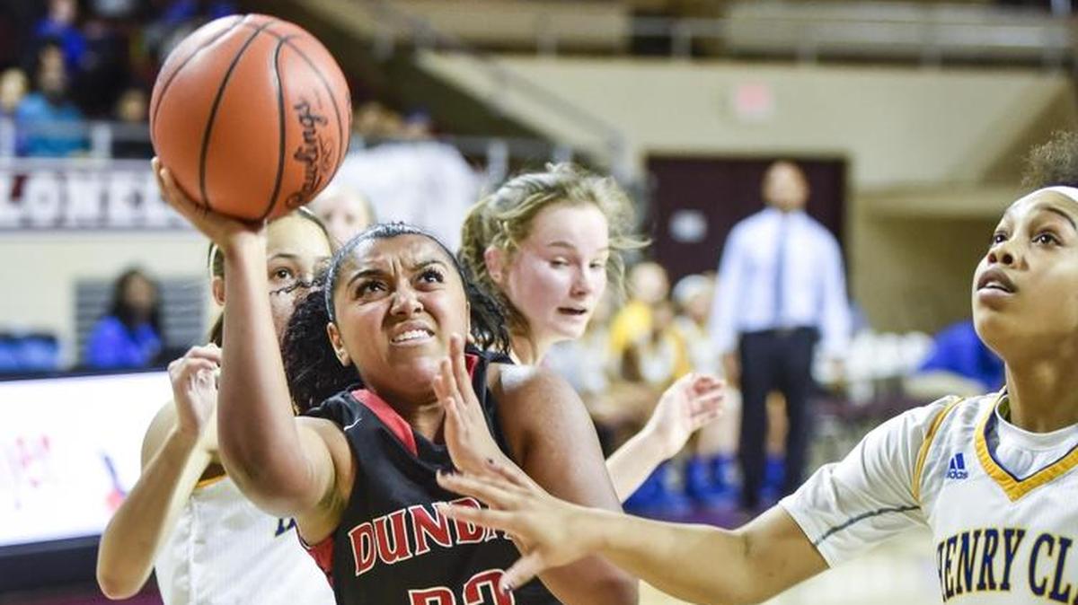 Dunbar's Mashayla Cecil (23) shoots over Henry Clay's Kiya Thompson (24), during the opening round of the girls 11th Region tournament, Monday, February 29, 2016, at EKU in Richmond.