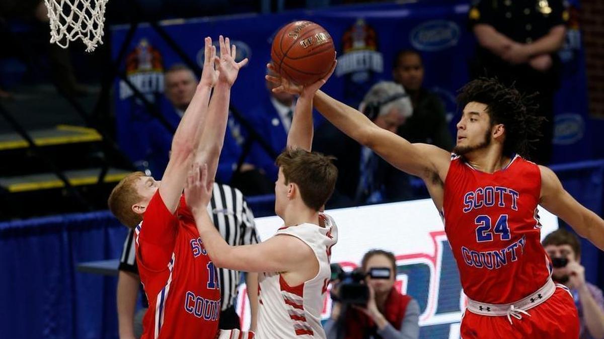 Corbin guard Matthew Taylor (32) was fouled by Scott County guard Cooper Robb (10) before Scott County forward Michael Moreno (24) could make the block as Scott County played Corbin in the quarterfinal round of Whitaker Bank/KHSAA Boys' Sweet Sixteen in Rupp Arena. This is second quarter action.