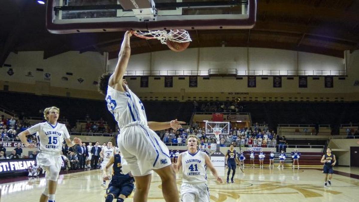 Lexington Catholic's Zan Payne (23) dunks the ball as Sayre's Jayden Blanton (1) looks on, during the boys’ 11th Region Tournament semifinals, Saturday, March 4, 2017, at EKU's McBrayer Arena in Richmond.