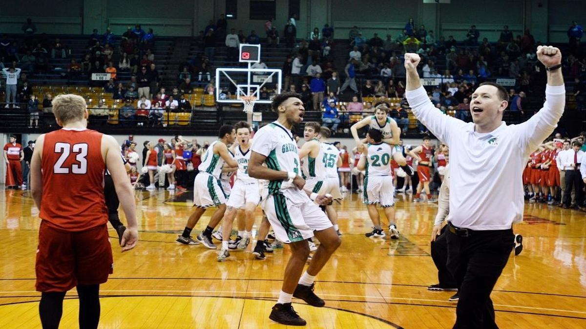 Meade County Coach Jason Tripure, senior James Baker and the rest of the Green Wave celebrate winning the Boys' 3rd Region Basketball Tournament championship after defeating Daviess County.