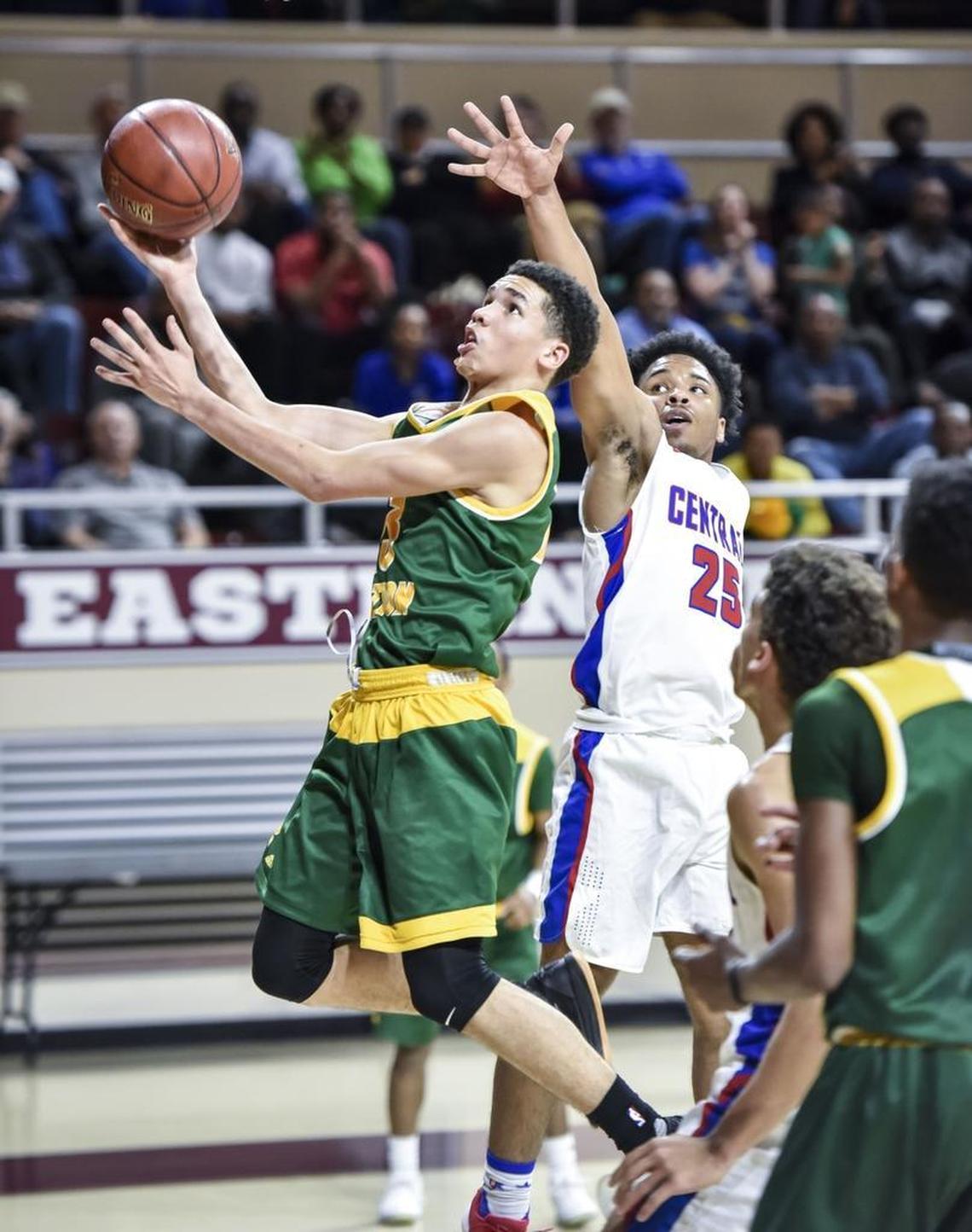 Bryan Station's Myles Morones (23) shoots in the lane against Madison Central's Quaezhan Charlton (25), during the first round of the 11th Region tournament, Wednesday night, February 28, 2018, at EKU's McBrayer Arena in Richmond.