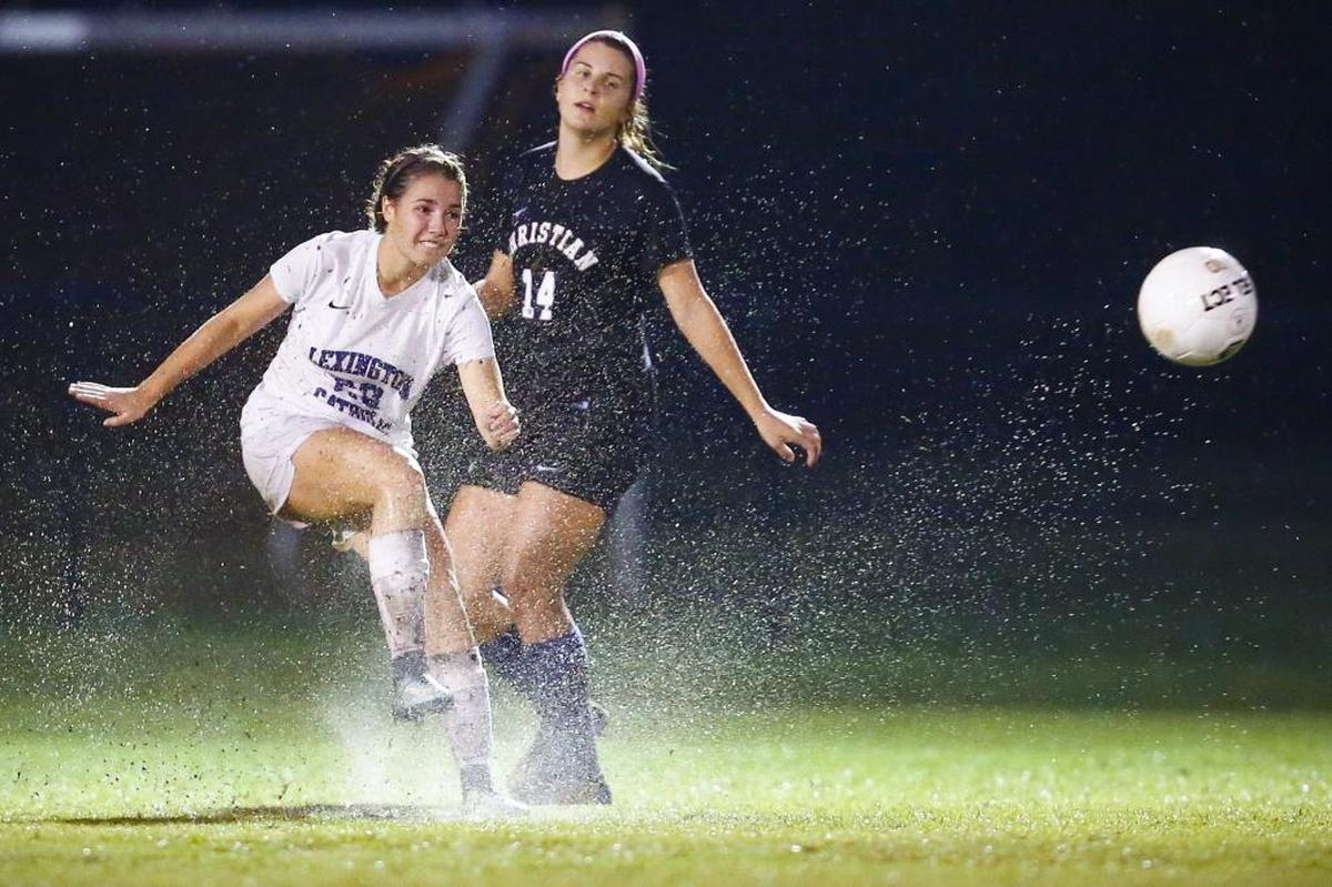 Lexington Catholic's Sidney Schoff (20) kicks the ball down field past Lexington Christian Lexi Sheely's (14) during their 43rd District semifinal soccer game at Lexington Christian High School in Lexington, Ky., Tuesday, Oct. 10, 2017. Lexington Catholic beat Lexington Christian 4-0.