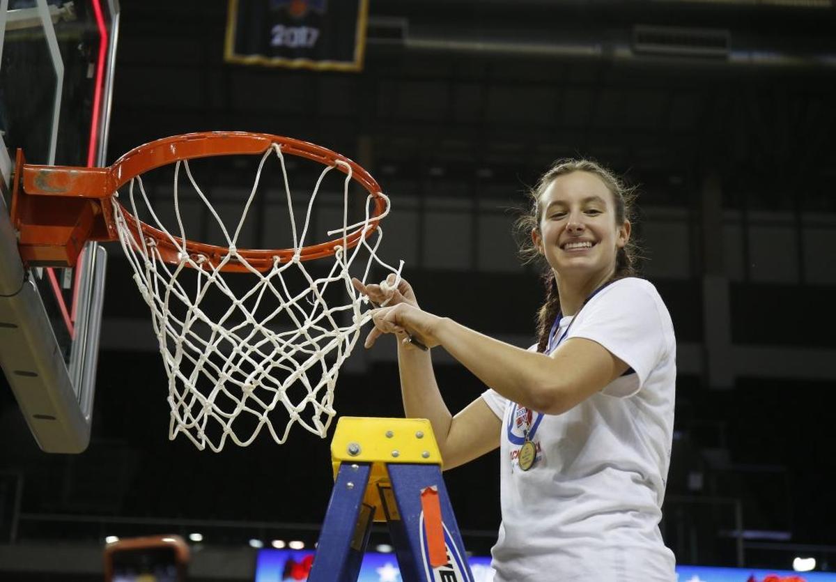 Mercer County’s Seygan Robins cut the net after the Titans defeated Mercy for their second consecutive state championship.