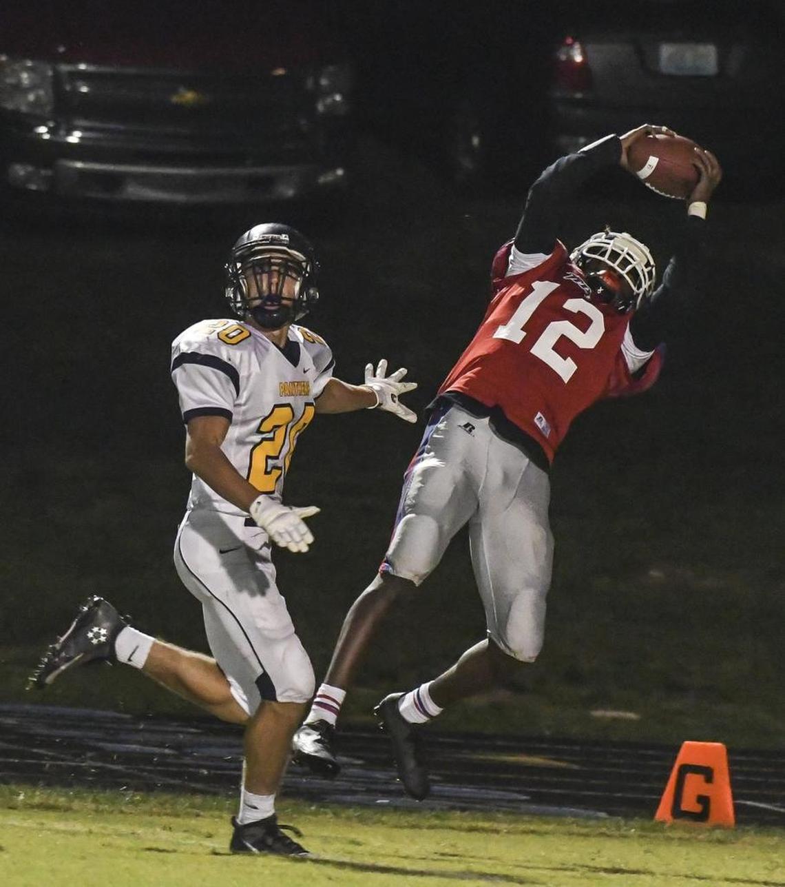 Mercer County High School's Trevon Faulkner (12) catches a touchdown past Knox Central's Dane Imel (20) in the second quarter during the first-round Class 4A game Friday, November 4, 2016., at Mercer County High School in Harrodsburg, KY.
