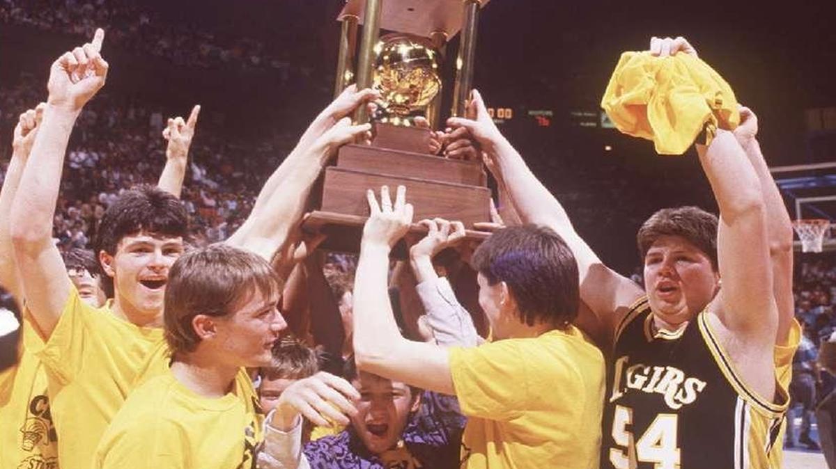 Eugene “Boxhead” Rawlings, No. 54, and the Clay County Tigers celebrated in Rupp Arena after beating Ballard 76-73 in overtime to claim the 1987 Boys’ Sweet Sixteen championship.
