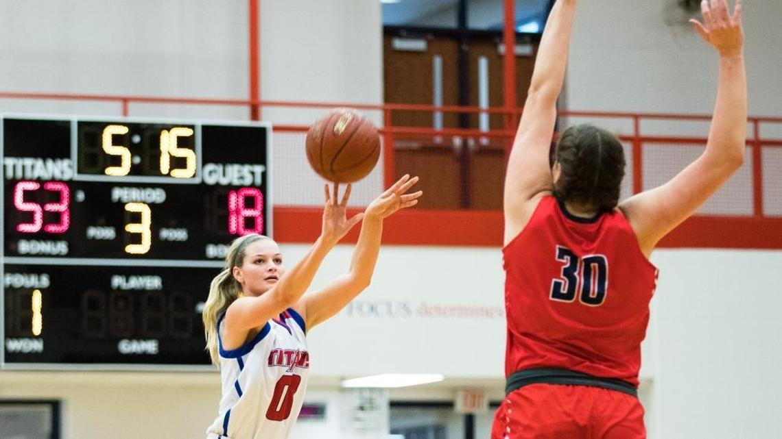 Mercer County’s Emma Davis (0) shot while Butler's Molly Lockhart (30) defended as host Mercer defeated Butler 68-45.