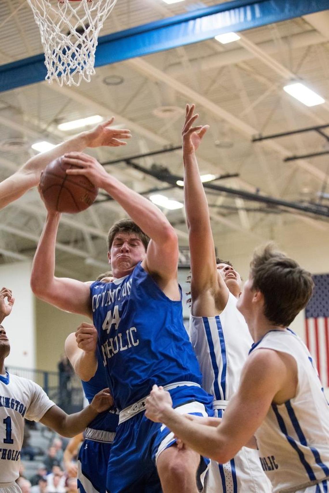 Covington Catholic's Jake Walter (44) with the rebound as host Lexington Catholic came up short 54-53 against Covington Catholic on Wednesday Nov. 29, 2017 in Lexington, Ky.