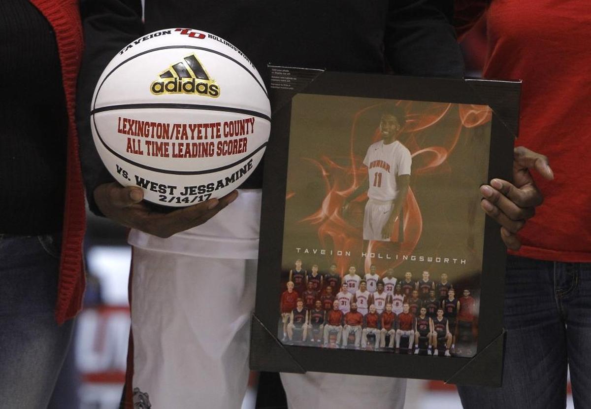 Paul Laurence Dunbar's Taveion Hollingsworth was presented a commemorative basketball as he was honored as Lexington's all-time leading scorer during senior night festivities prior to tonight's game against Scott Co. in the S. T. Roach Gymnasium in Lexington, Ky., Thursday, February 17, 2017.