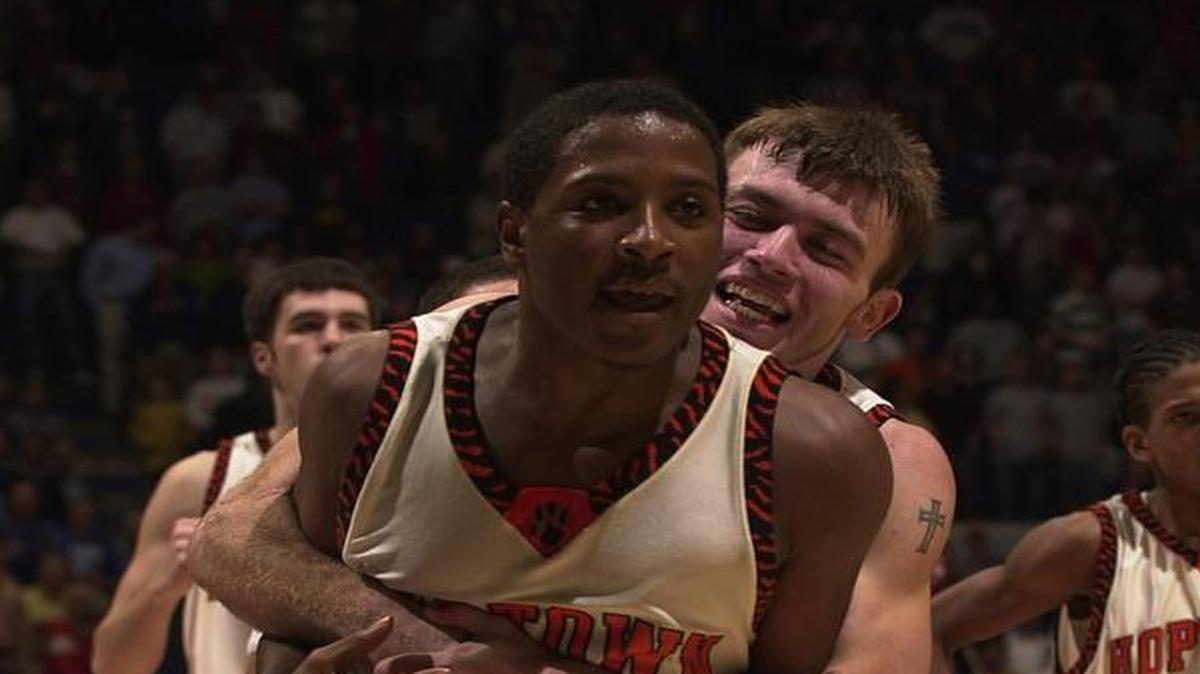 Hopkinsville’s Lartavious Banks was hugged by teammate Dustin Lopez after Banks made the game-winning shot against Daviess County in 2003.