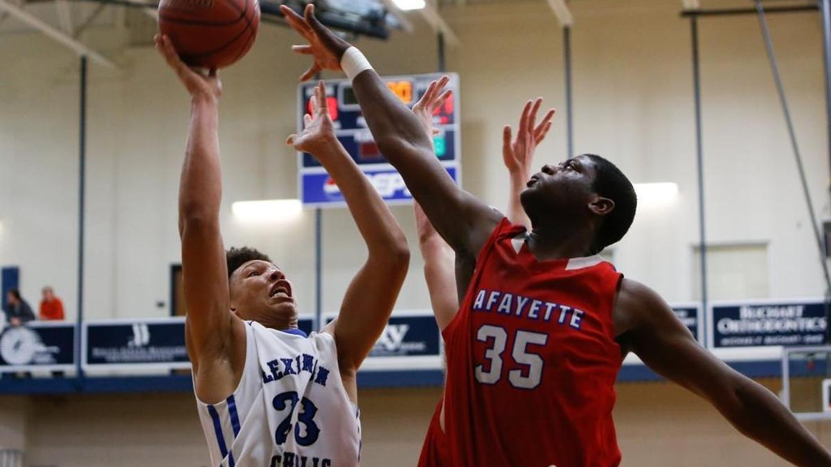 Lexington Catholic Knights' Zan Payne puts up a shot over Lafayette Generals' Devontae Hayes during the semifinals of the 43rd District tournament at the Beuter Gymnasium at Lexington Catholic High School in Lexington, KY on Wednesday, February 22, 2017.