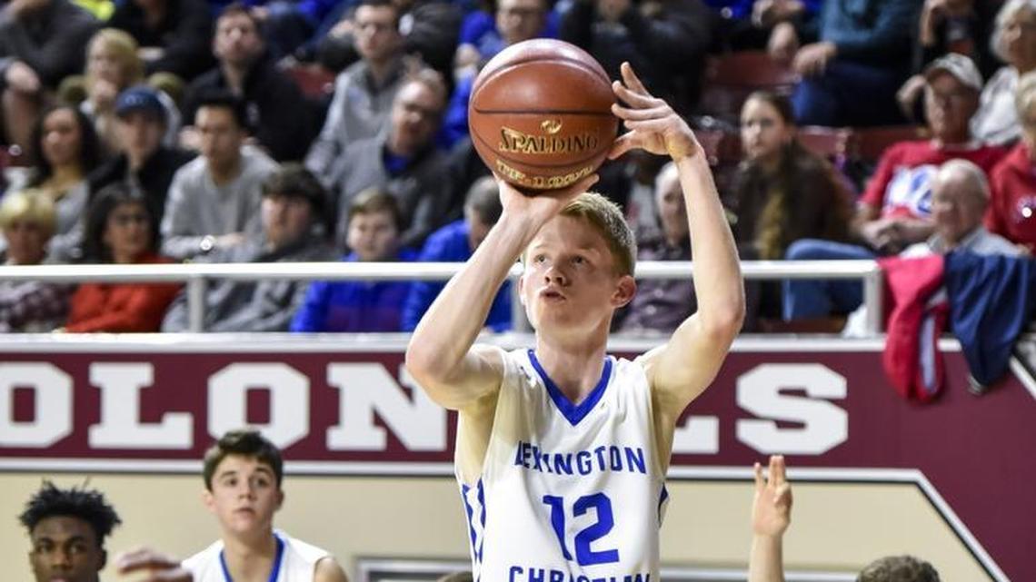 LCA's Will Hacker (12) shoots a 3-pointer over Frankfort's Jevon Bush (10), during the first round of the 11th Region tournament, Wednesday night, February 28, 2018, at EKU's McBrayer Arena in Richmond.