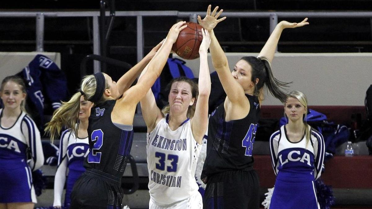 Shelby Valley's Cassidy Rowe, left, and Alyssa Elswick tie up Lexington Christian's Emilie Teall in the All 'A' Classic at Alumni Coliseum in Richmond, Ky., Wednesday, January 24, 2018.