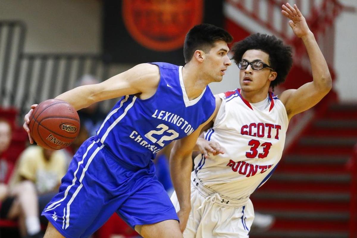 Lexington Christian's Kyle Rode (22) drives down court against Scott County's Lorenzo Williams (33) during their game at Scott County High School in Georgetown, Ky., Thursday, Dec. 7, 2017. Scott County beat Lexington Christian 68-59.
