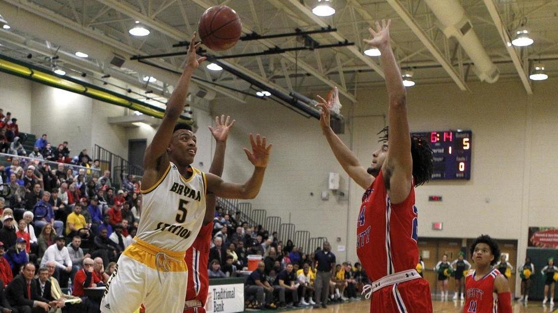 Bryan Station’s Eric Boone shot against Scott County’s Michael Moreno during their game at Bryan Station on Jan. 22. Both teams will play in this week’s 42nd District Tournament at Frederick Douglass High School in Lexington.
