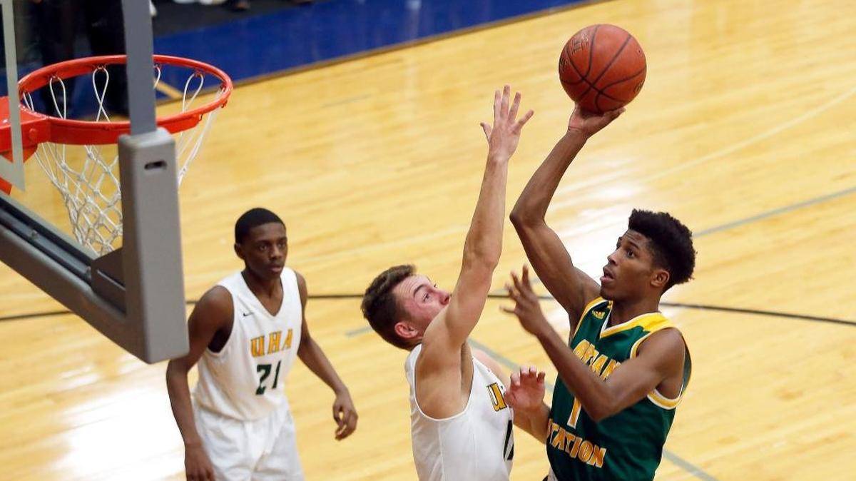 Bryan Station's Terrance Clayton-Murphy (1) scored on University Height's Drew McGowan (11) in the 3rd quarter as Bryan Station High School played University University Heights in theTraditional Bank Holiday Classic played at Lexington Catholic High School in Lexington Ky., Wednesday, December 27, 2017. Bryan Station won 82-69.