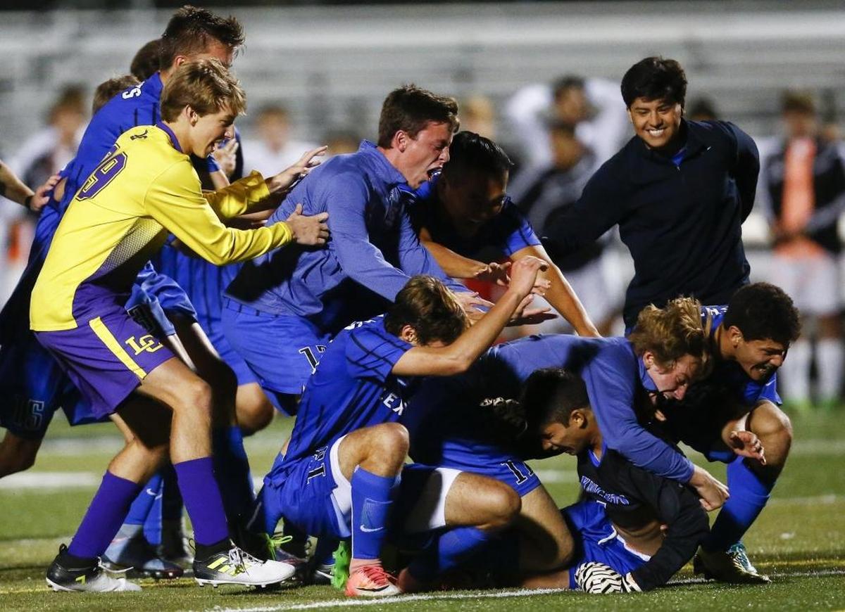 Lexington Catholic celebrates following the 43rd District finals against Paul Laurence Dunbar at Paul Laurence Dunbar High School in Lexington, Ky., Thursday, Oct. 12, 2017. Lexington Catholic beat Paul Laurence Dunbar 2-1 on penalty kicks.