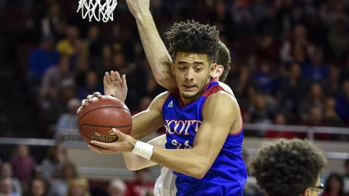 Scott County's Michael Moreno (24) grabs a rebound over Lexington Catholic's Max Sparkman (14), during the boys 11th Region Tournament finals, Monday, March 6, 2017, at EKU's McBrayer Arena in Richmond.