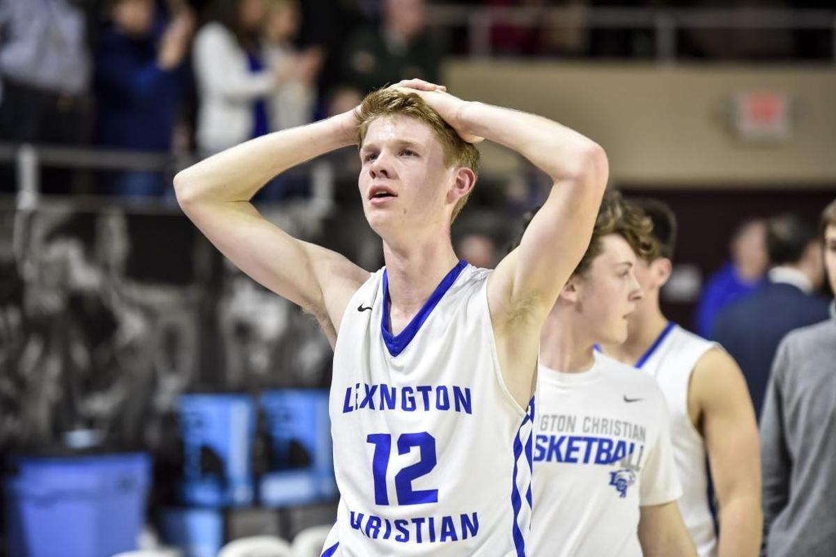 Lexington Christian’s Will Hacker (12) walked off the court after missing a three-pointer near the end of Monday’s game against Scott County.