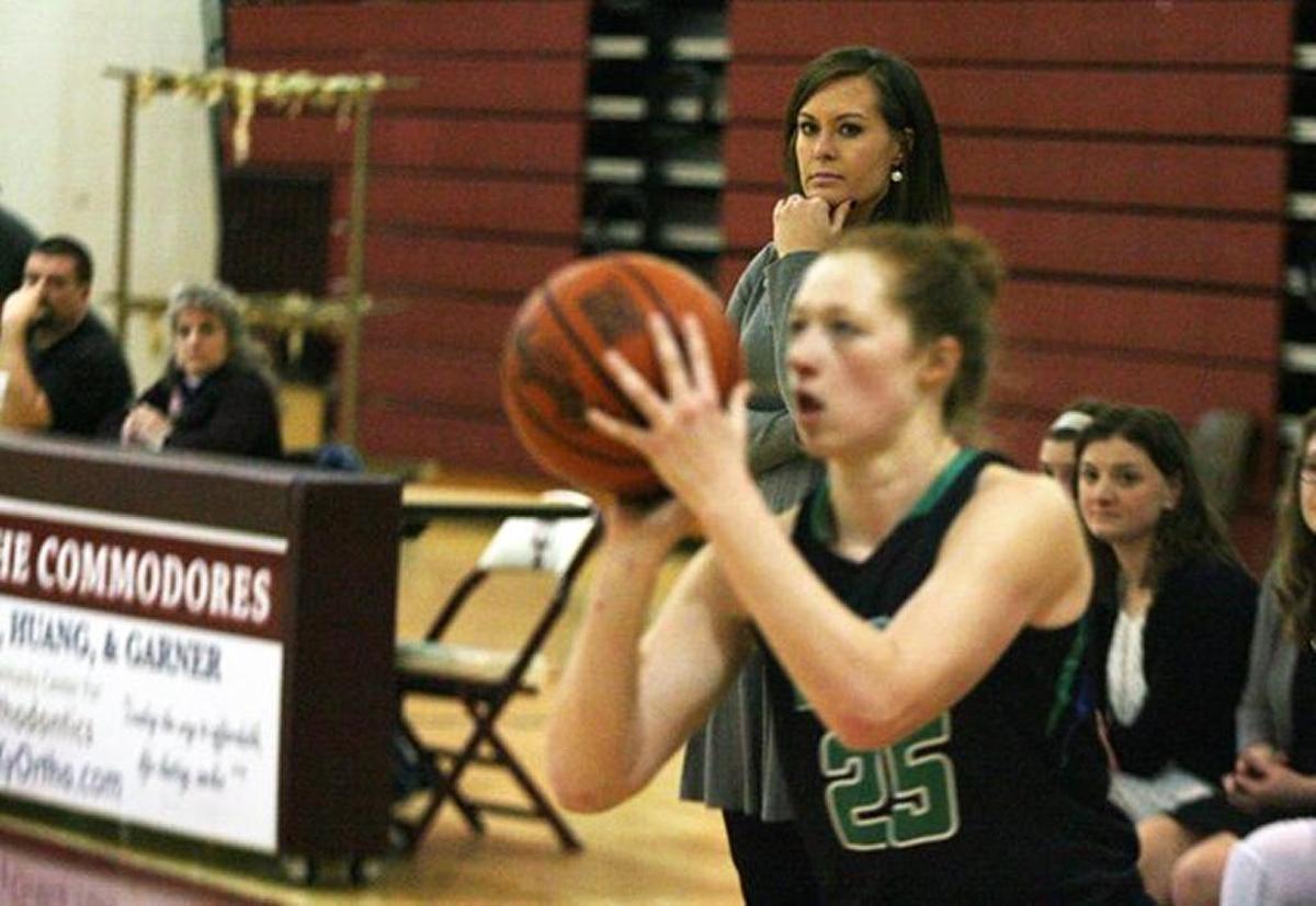 Jacqueline Coleman, background, coached East Jessamine and her daughter Emma Young a year ago and thought she was done with coaching for a while after last season. Instead, she was called back into duty by Nelson County.