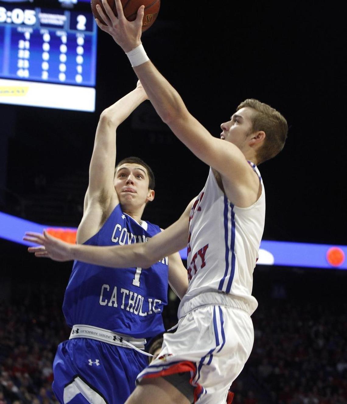 Scott County's Bryce Long shot Sunday against Covington Catholic's C. J. Frederick in the championship game of the 2018 Whitaker Bank KHSAA Sweet 16 basketball tournament at Rupp Arena.
