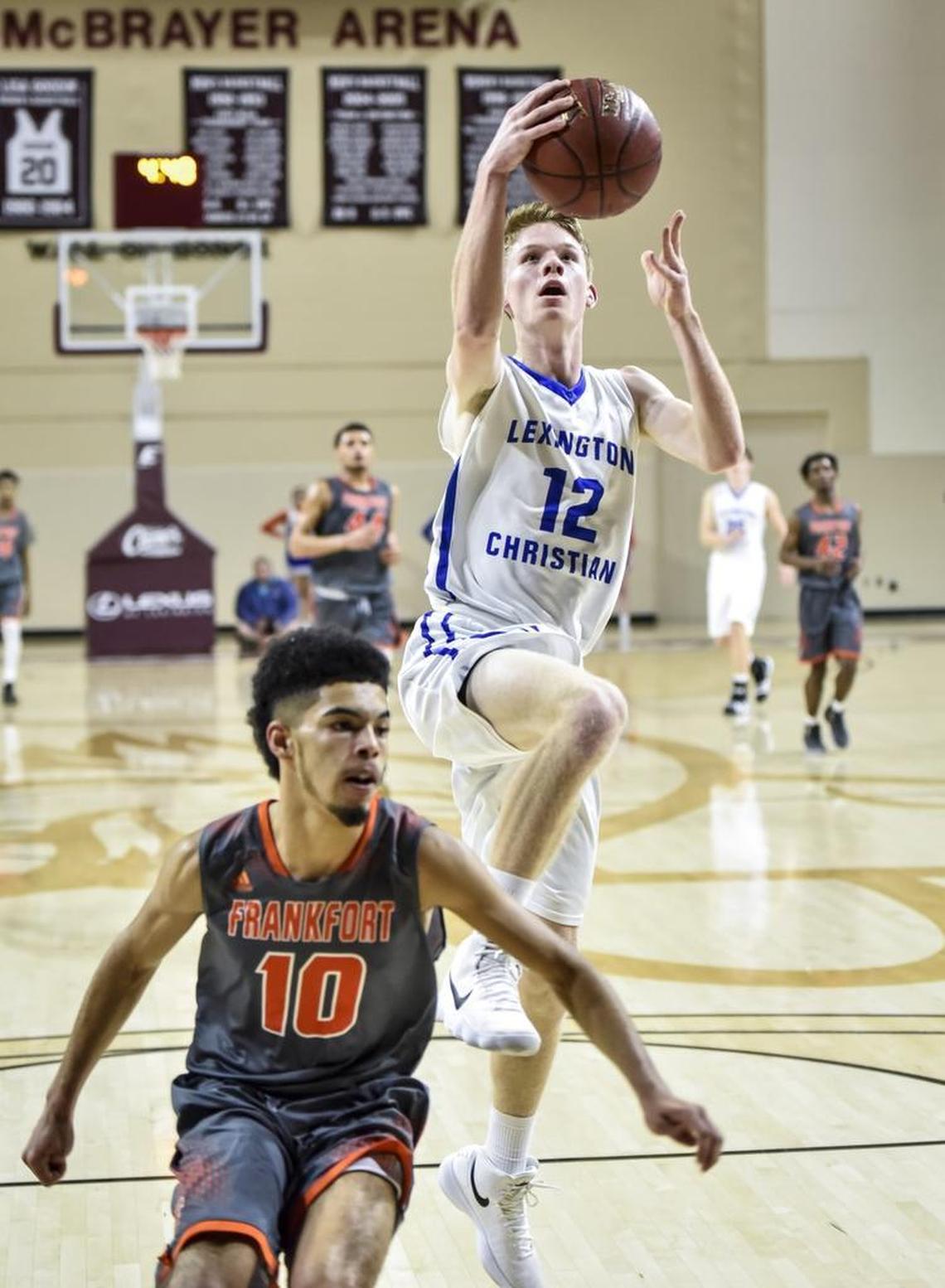LCA’s Will Hacker (12) shot two of his game-high 25 points over Frankfort’s Jevon Bush (10), during the first round of the 11th Region tournament Wednesday at EKU's McBrayer Arena in Richmond.