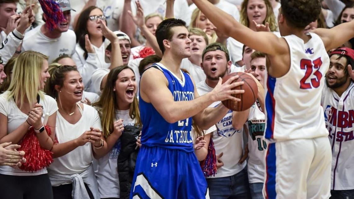 Covington Catholic's AJ Mayer (21) looks to inbound the ball against Madison Central's Dustin Geralds (23), and under the pressure of the Madison Central fans, February 16, 2018, at Madison Central High School in Richmond.