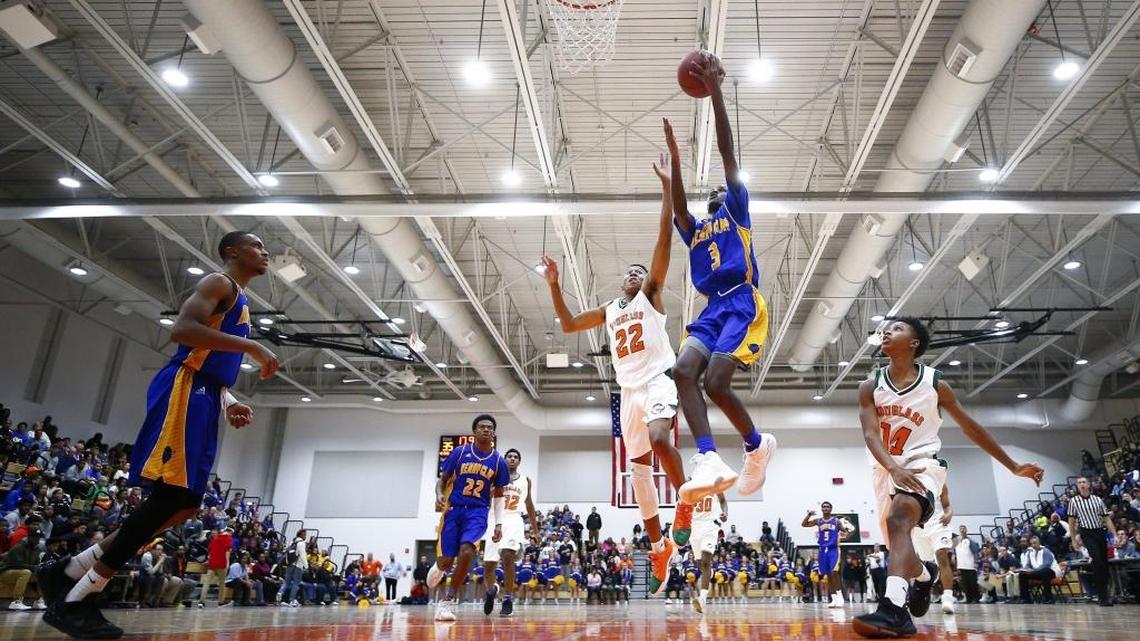 Henry Clay's Marques Warrick (3) shoots past Frederick Douglass' Jayden Brown (22) during their game at Frederick Douglass High School in Lexington, Ky., Tuesday, Nov. 28, 2017.