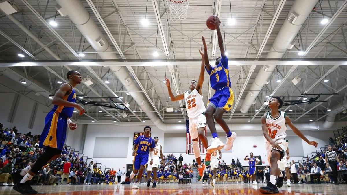 Henry Clay's Marques Warrick (3) shoots past Frederick Douglass' Jayden Brown (22) during their game at Frederick Douglass High School in Lexington, Ky., Tuesday, Nov. 28, 2017.